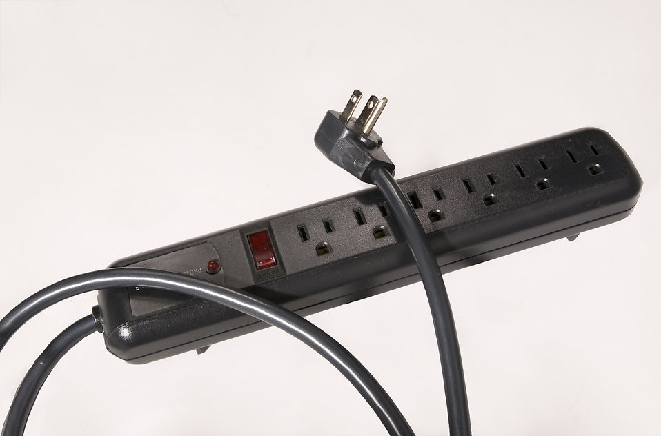 Isolated black surge protector strip with 6 outlets
