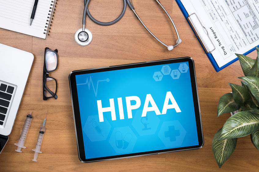 HIPAA displayed on tablet along with doctors equipment